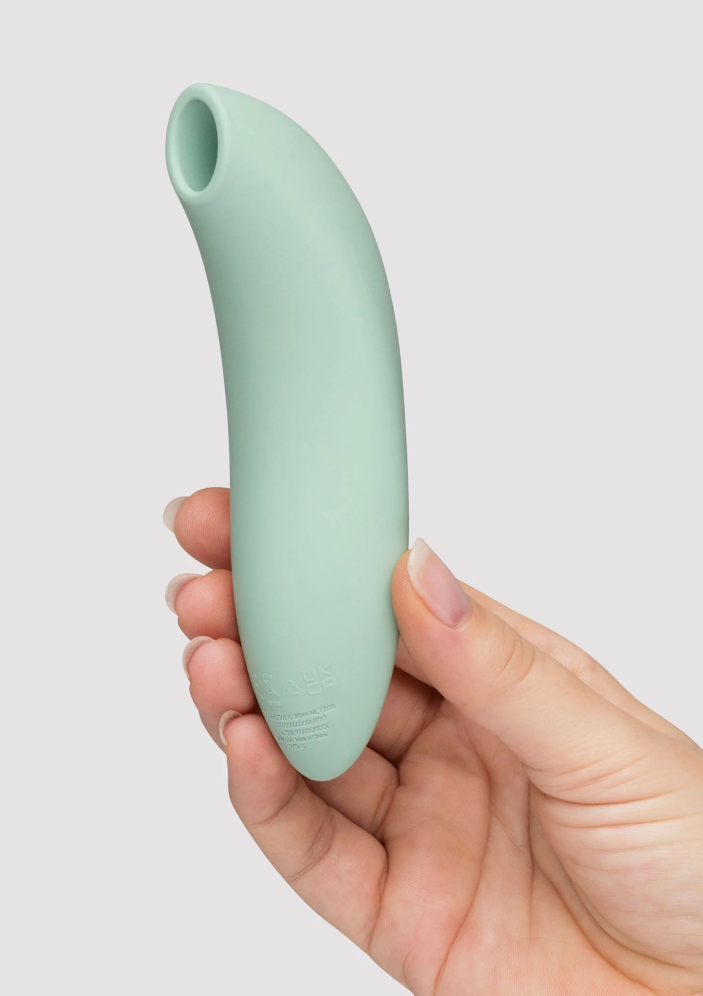 Mintgroene vibrator in hand, zijaanzicht met ronde kop