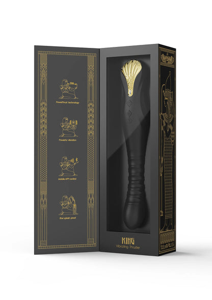 Doosverpakking met zwarte dildo en gouden ornamentillustraties.