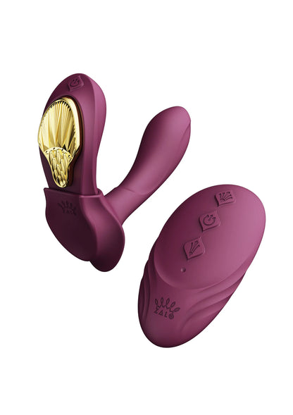Paarse draagbare vibrator en ovale achterplaat met gouden binnenkant
