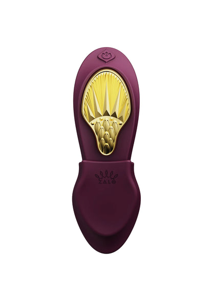 Paars Zalo draagbare vibrator met gouden opening en opgestikte bedieningsknop.