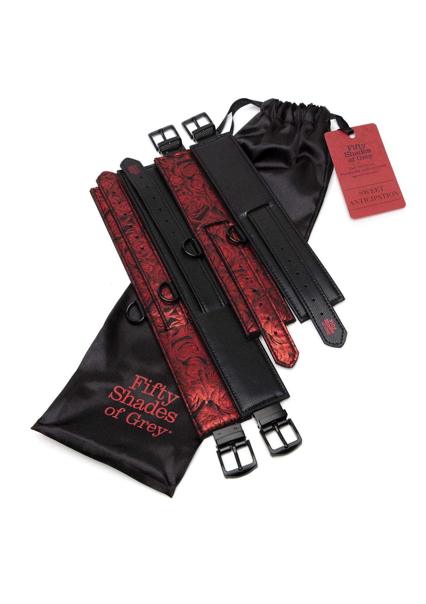Restraint set opgevouwen: zwarte riemen, rood patroonhandboeien, zakje en kaart